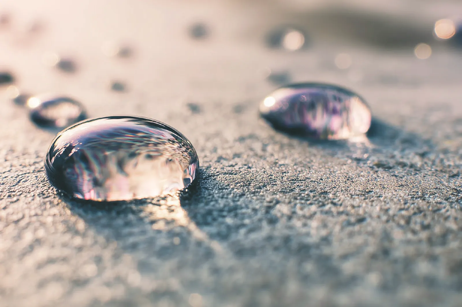 Two drops of water standing on the textured surface of a cured BAS Flexcoat membrane.