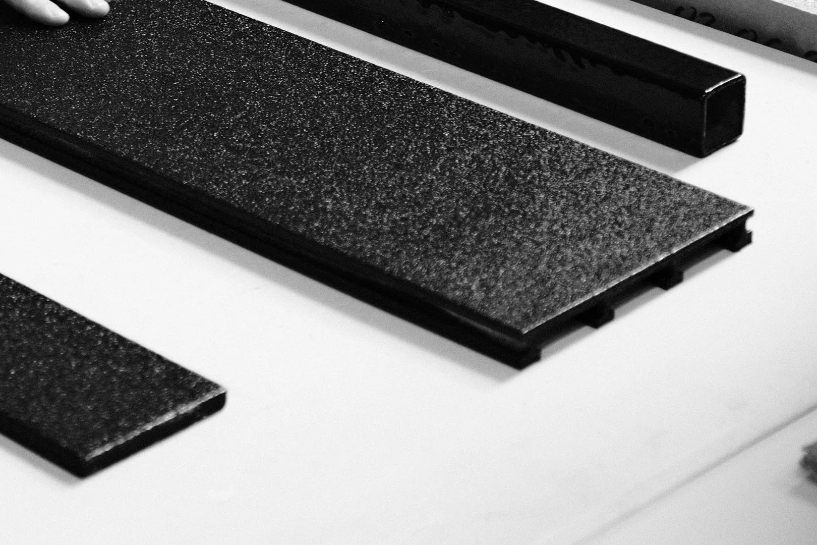 Two BAS Boards on a workshop table, one showing its textured coated surface and open end profile.