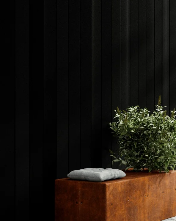 Black ribbed BAS Panels cladding beside a corten planter.
